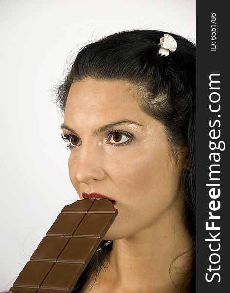 Young woman eating a delicious chocolate. Young woman eating a delicious chocolate