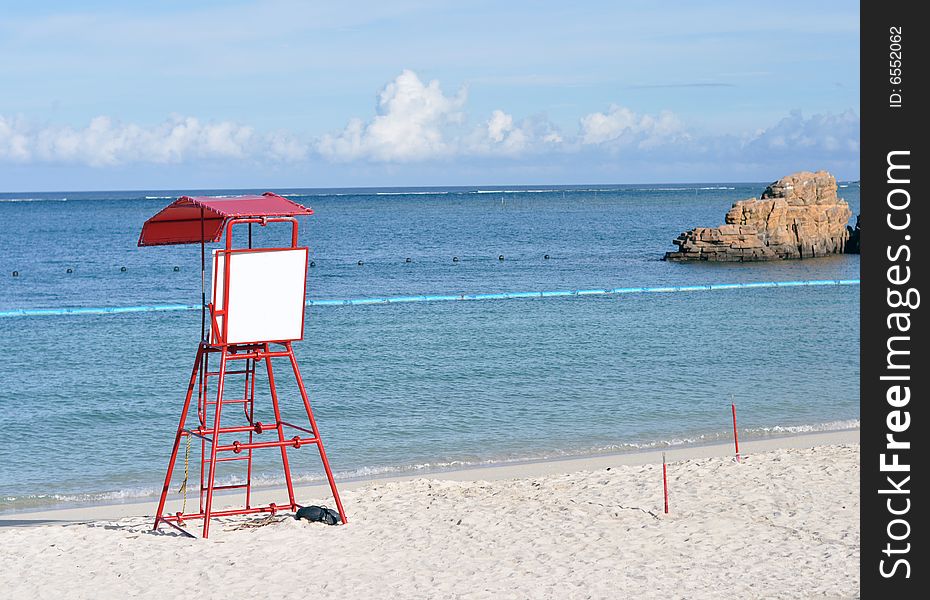 Blue beach with white sign on a lifeguard post. Blue beach with white sign on a lifeguard post