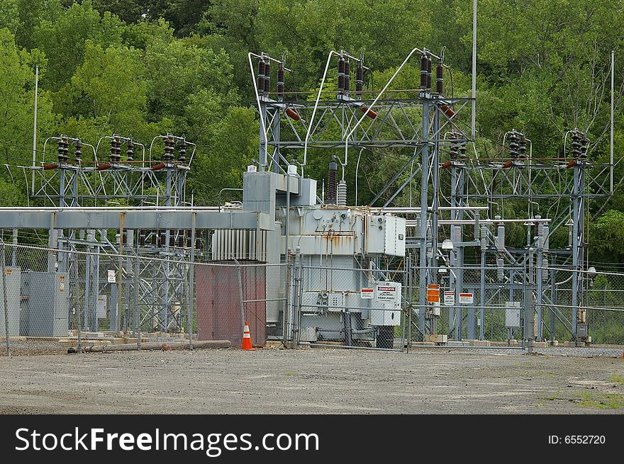 Electrical Power Transfer Station with Trees in the Background. Electrical Power Transfer Station with Trees in the Background