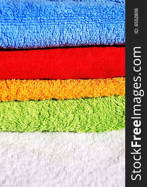 Stack of clean colorful towels close-ups