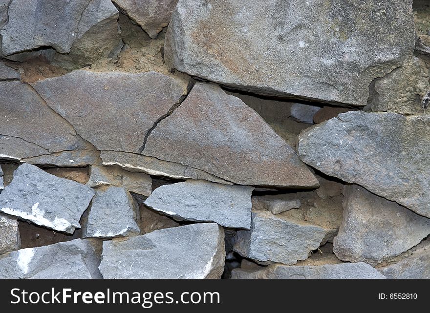 Wall from old granite sharp stones. Wall from old granite sharp stones