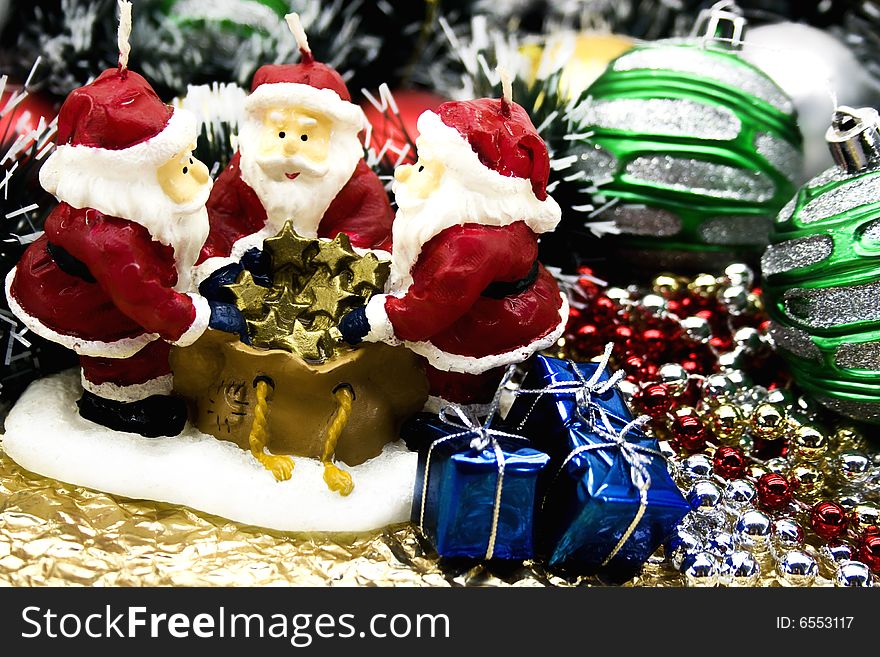 New Year's candle  Santa Claus with Christmas-tree decorations