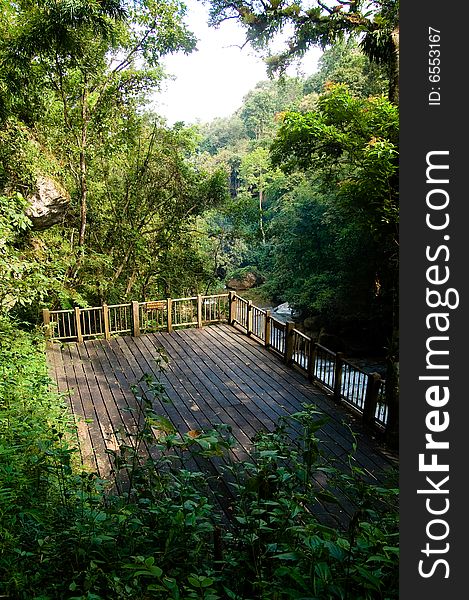 A wooden terrace standing on top of a river. A wooden terrace standing on top of a river.