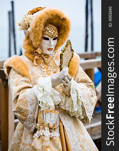 White and gold costume at the Venice Carnival. White and gold costume at the Venice Carnival