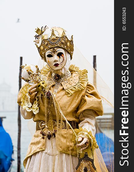 White and gold costume at the Venice Carnival. White and gold costume at the Venice Carnival