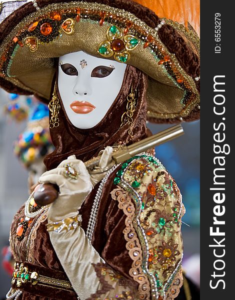 A person in costume holding a pistol at the Venice Carnival. A person in costume holding a pistol at the Venice Carnival