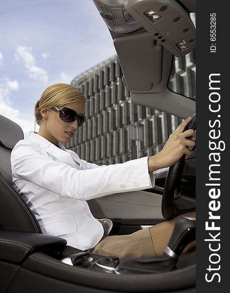 Beautiful blonde businesswoman in a cabrio car. Beautiful blonde businesswoman in a cabrio car