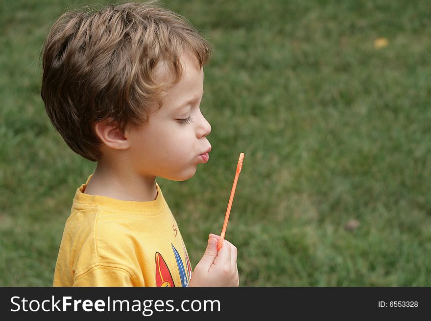 4 year old child blowing bubbles