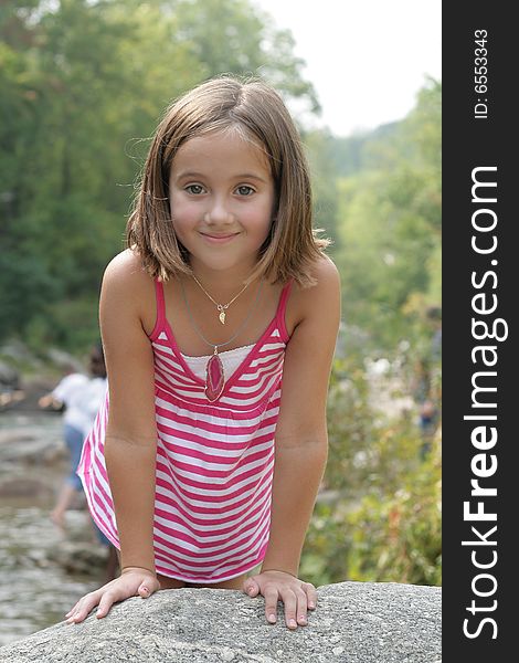 Beautiful 8 year old child by a stream. Beautiful 8 year old child by a stream