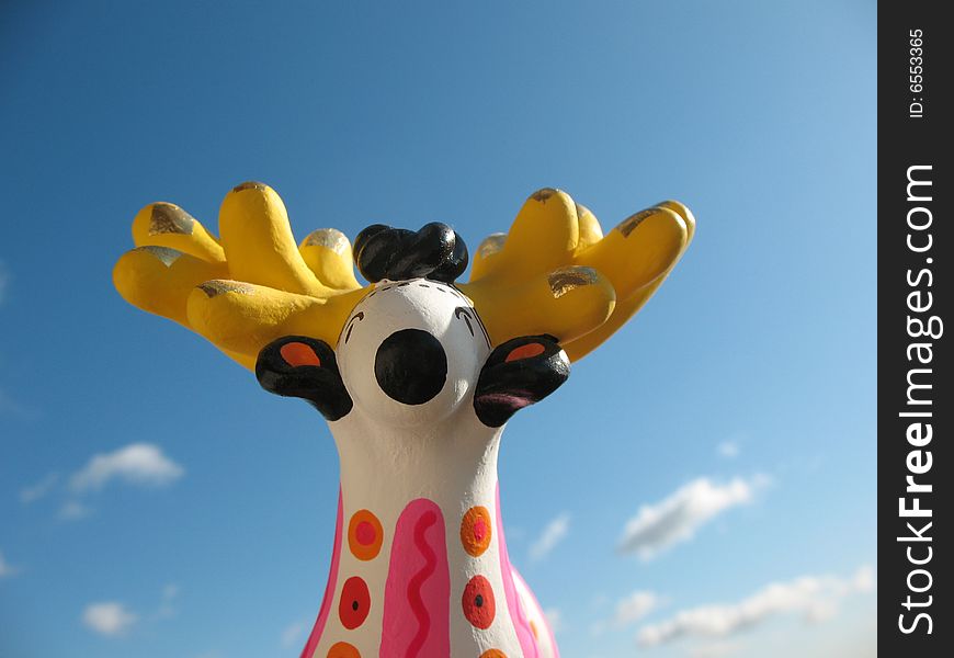 The golden antlers stag from fire-clay on the blue sky background. Hand made Dymka-toy. Russian national traditional toy from Vyatka town.
. The golden antlers stag from fire-clay on the blue sky background. Hand made Dymka-toy. Russian national traditional toy from Vyatka town.