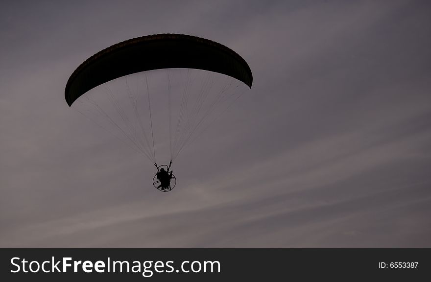 Paraglider Flight on dark cloudy