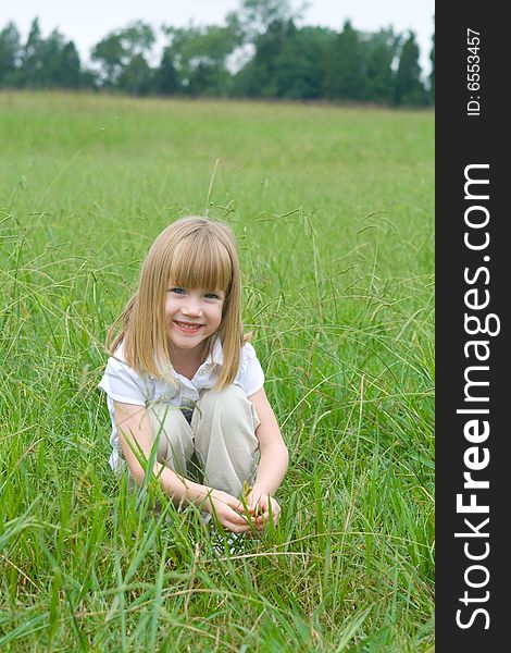 Four year old girl in the middle of a field. Four year old girl in the middle of a field