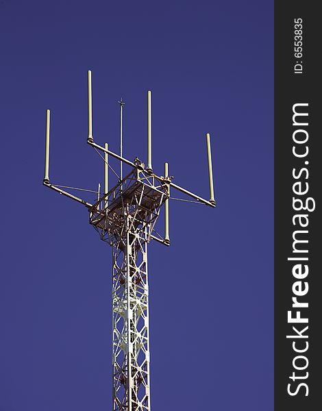 Telecommunications tower for broadcasting on perfect blue sky. Telecommunications tower for broadcasting on perfect blue sky