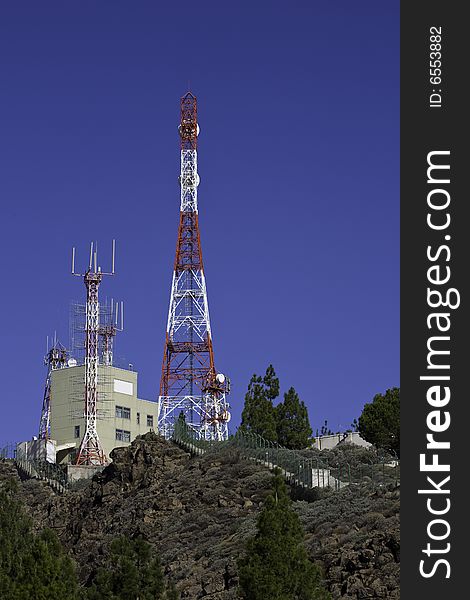 Telecommunications tower for broadcasting on perfect blue sky. Telecommunications tower for broadcasting on perfect blue sky