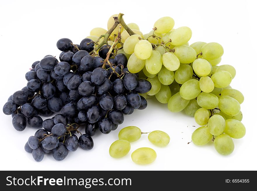 Two bunches of red and white grapes on white background. Two bunches of red and white grapes on white background