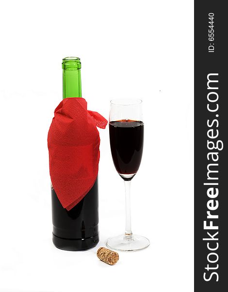 A green bottle of red wine and crystalline tall wineglass. A green bottle of red wine and crystalline tall wineglass