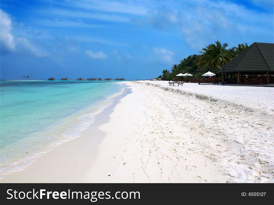 A tropical resort bay with white sand, turquoise clear waters  and blue sky. A tropical resort bay with white sand, turquoise clear waters  and blue sky
