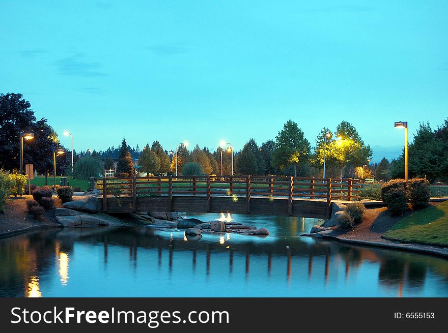 Bridge in the park at night with evening lights