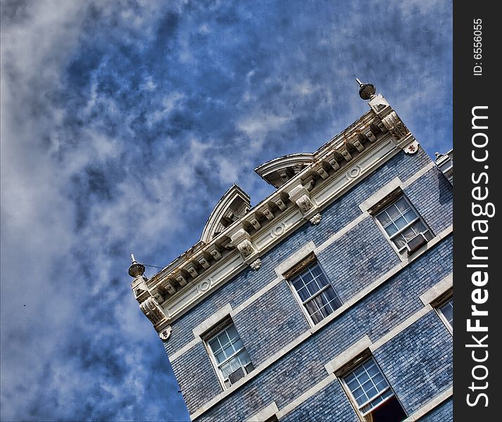 View of classic, historical blue building against a blue sky. View of classic, historical blue building against a blue sky.