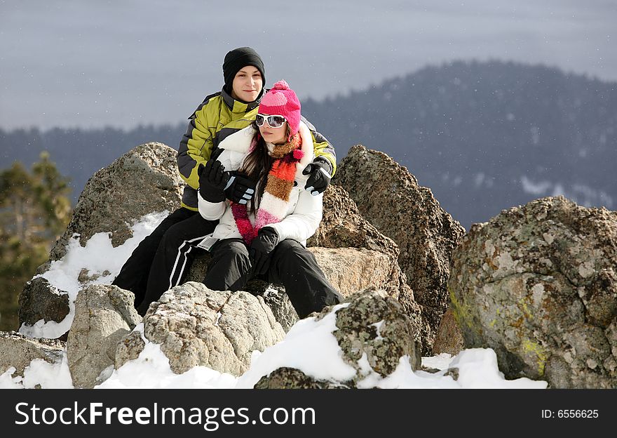 Happy young couple on the top of the mountain in winter. Happy young couple on the top of the mountain in winter