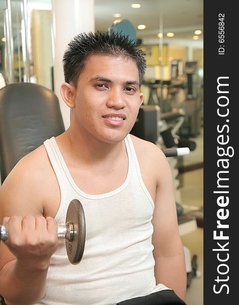 Man exercise in fitness center. Man exercise in fitness center