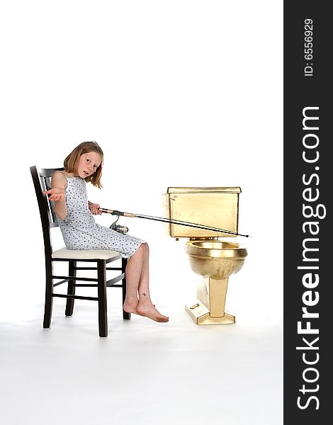 Girl sitting in chair and fishing in gold toilet. Girl sitting in chair and fishing in gold toilet