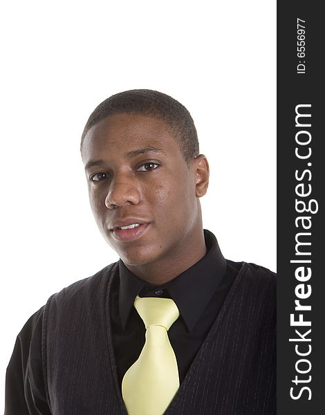 A handsome young black man in black shirt and sweater with a yellow tie. A handsome young black man in black shirt and sweater with a yellow tie