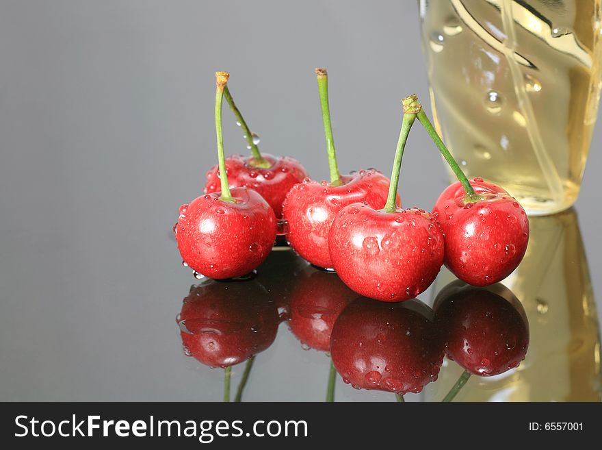 Fresh Cherry with Perfume on Glass