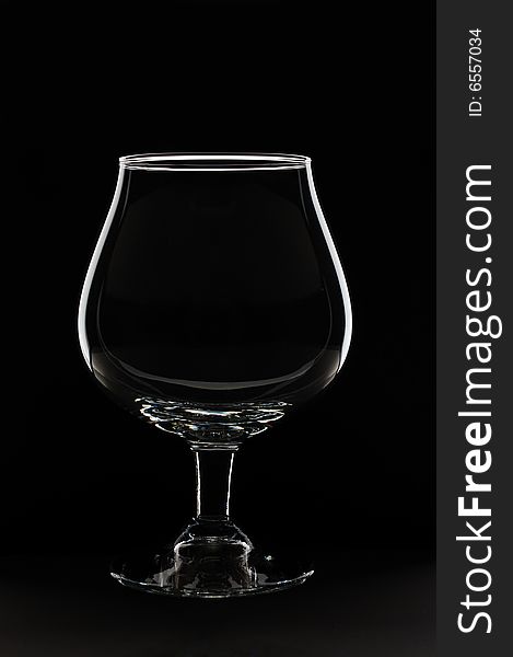 Empty glass against black background