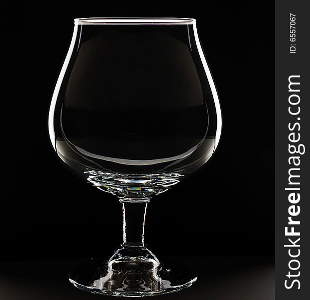 Empty glass against black background