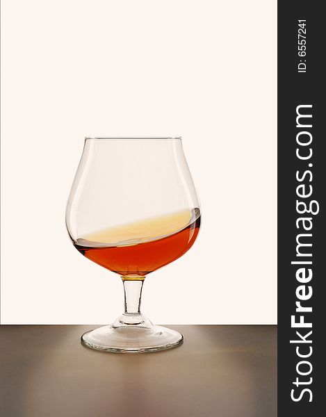 Glass of brandy against white background