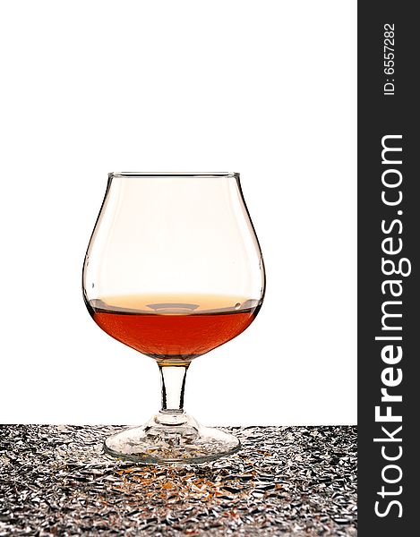 Glass of brandy against white background
