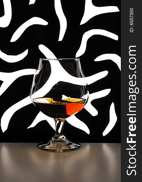 Glass of brandy against black-and-white background