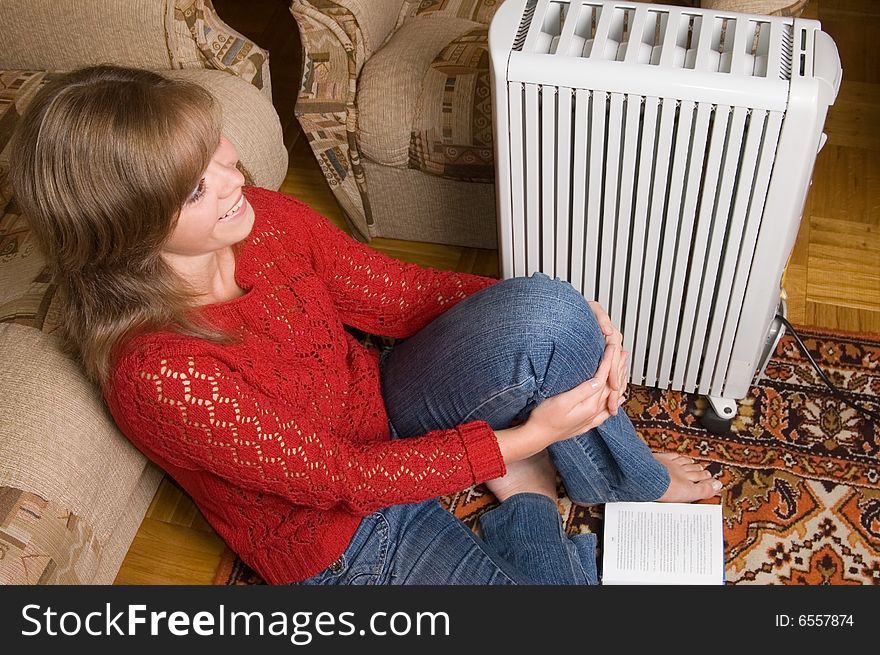 Woman sits on a carpet in a living room. Woman sits on a carpet in a living room