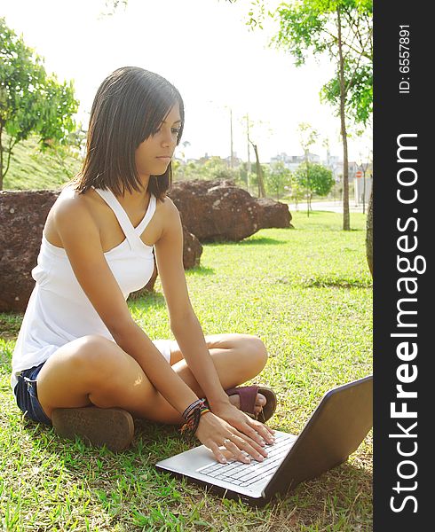 Beautiful teenager girl with notebook sat on grass. Beautiful teenager girl with notebook sat on grass