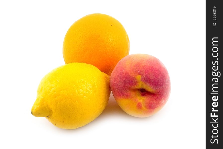 Beautiful useful tasty fruit lemon orange and peach on white background