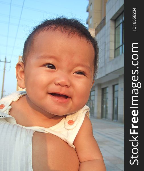 Happy baby on her mother's shoulder