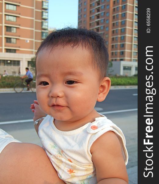 Happy baby on her mother's shoulder. Happy baby on her mother's shoulder