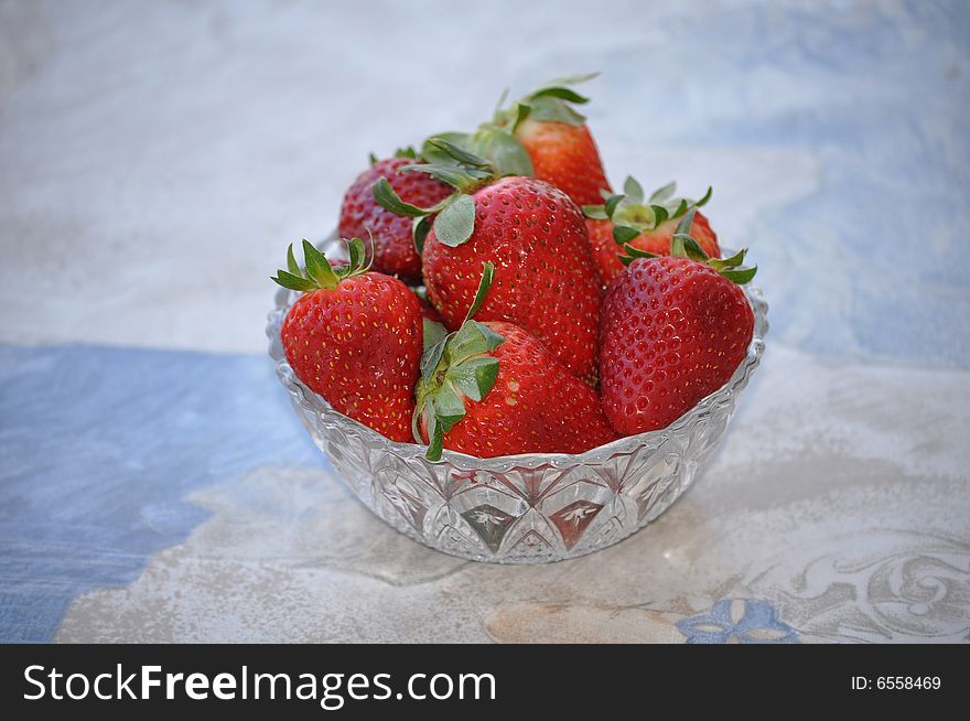 A crystal bowl with strawberries