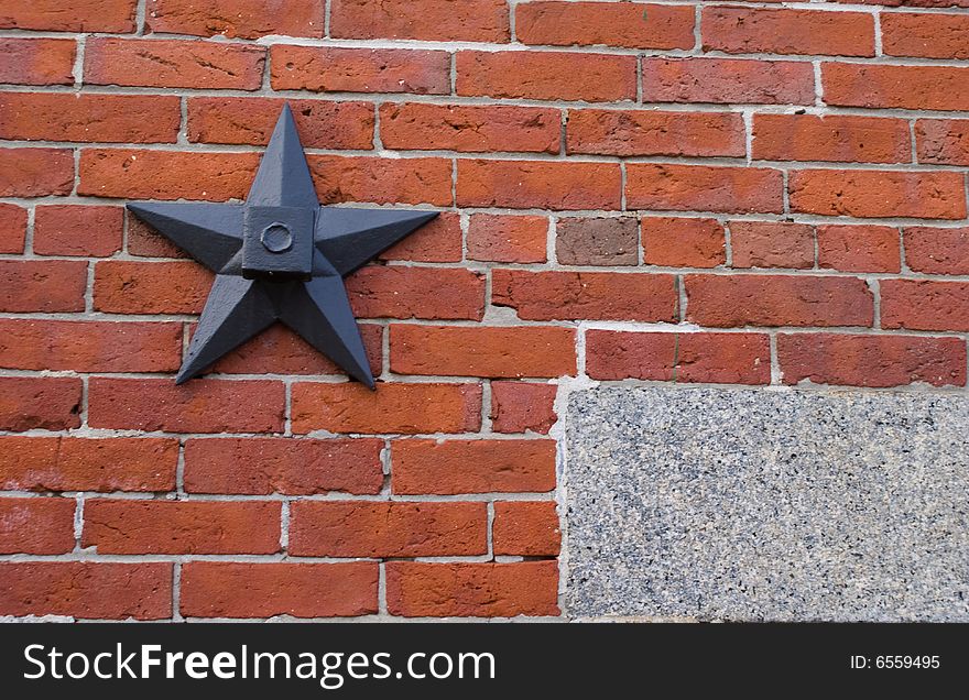 Architecture details of a historic building from the 1880's. The stars are wall anchors that are rods that help hold the bricks to the side of the building