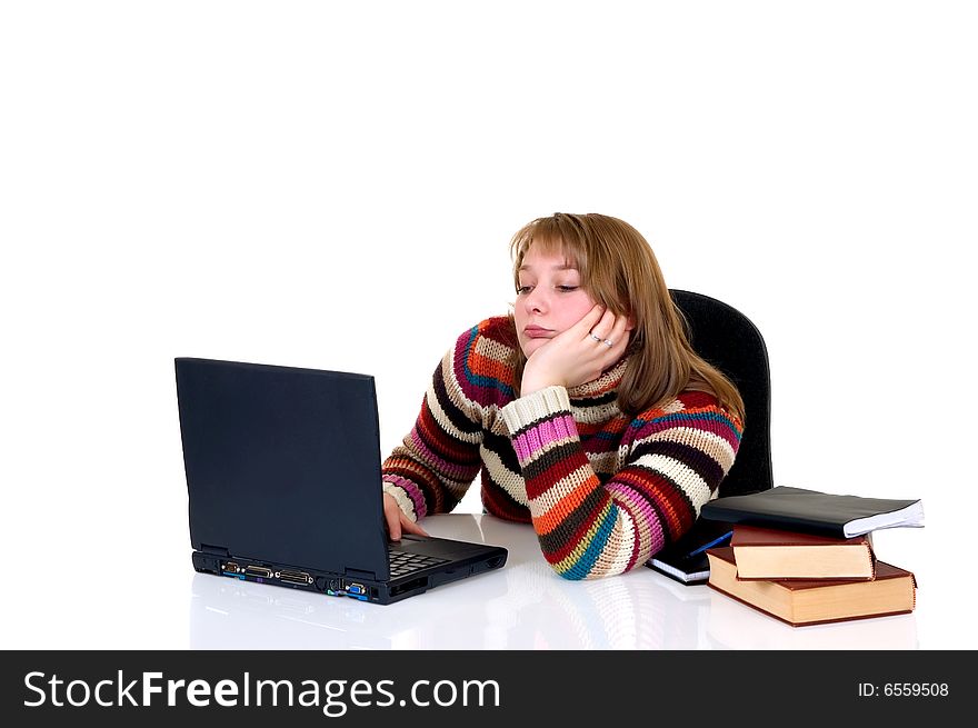 Teenager student doing homework with laptop and books on desk, with background, reflective surface