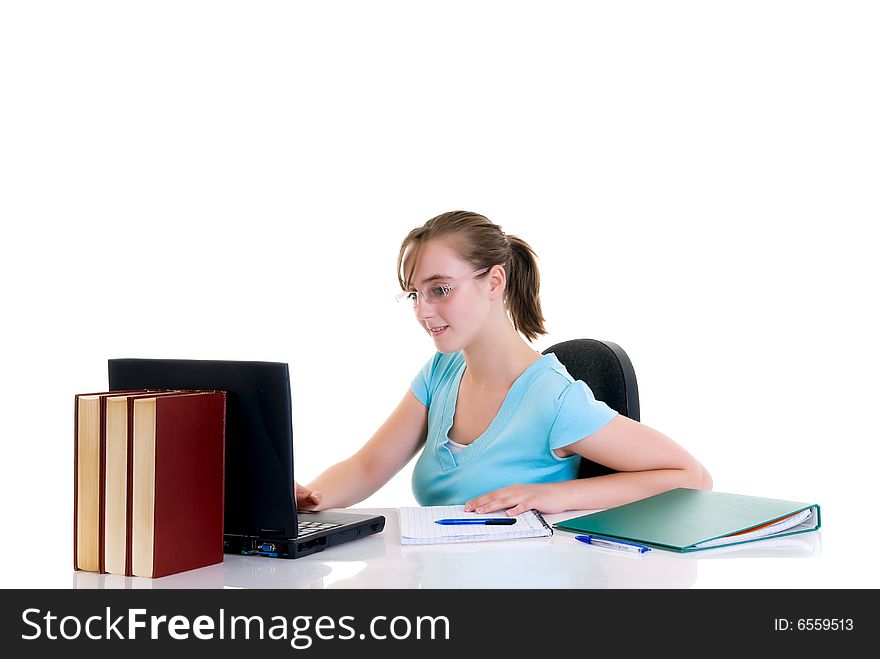 Happy smiling teenager girl on desk doing studying and homework
