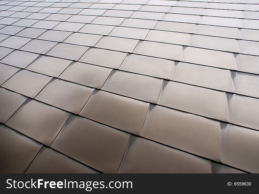 Steel panels on the outside of a building with arch patterns in the metal
