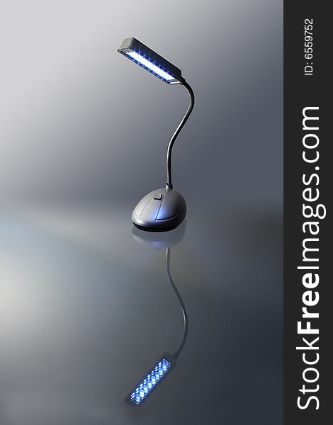 Modern luminous table lamp standing on gray background