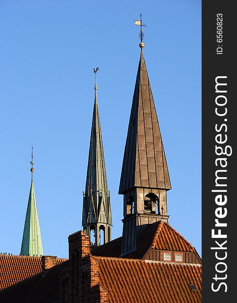 Three church towers with a blue sky background