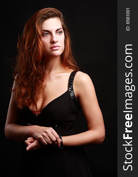 Portrait of beautiful woman over black background