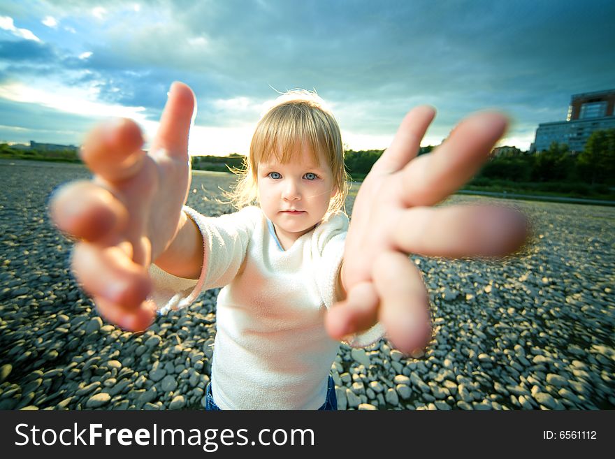 Little girl grief look and reach out hands