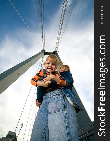 Mother hold child on bridge outdoor