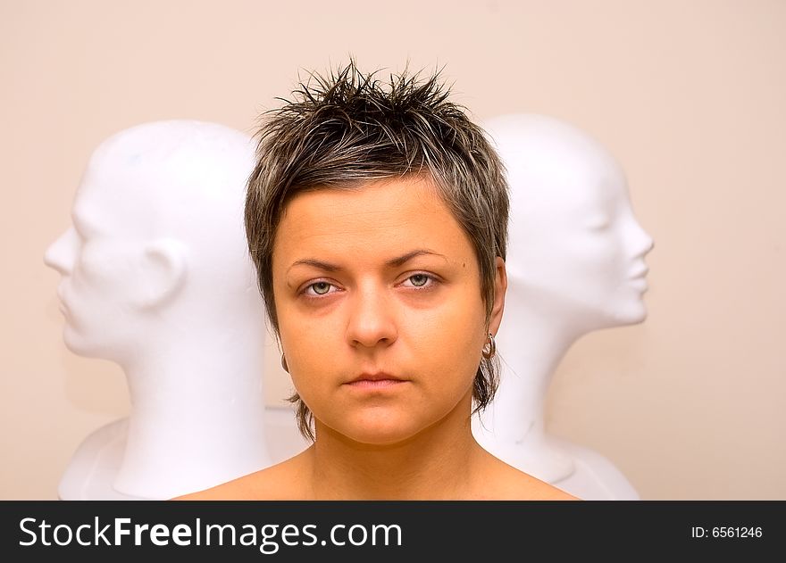 Portrait of woman and two plastic heads