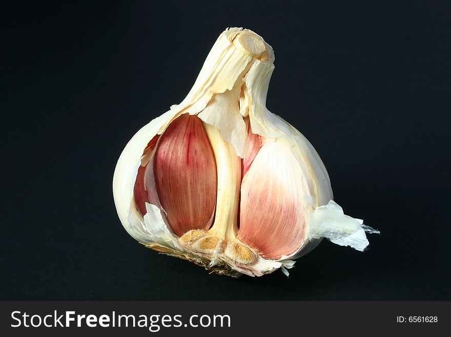 A garlic bulb isolated on a black background